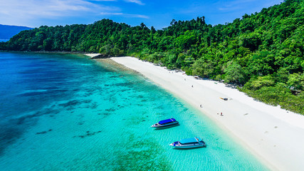 Aerial top view beautiful nature scenic vacation beach bright and clear blue sea with boat for...