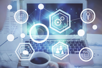 Computer on desktop with social network hologram. Multi exposure. Concept of international people connections.