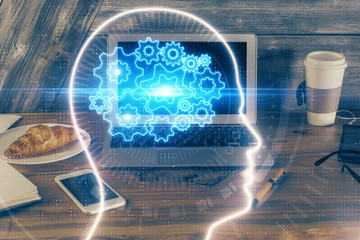 Multi exposure of work table with computer and brain hologram. Brainstorm concept.