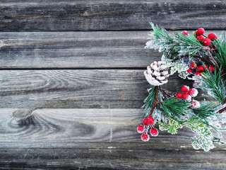 christmas fir tree branch with cones winter berries in snow