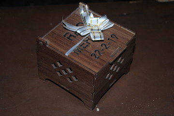 Gift box with ribbon and bow on wooden background texture