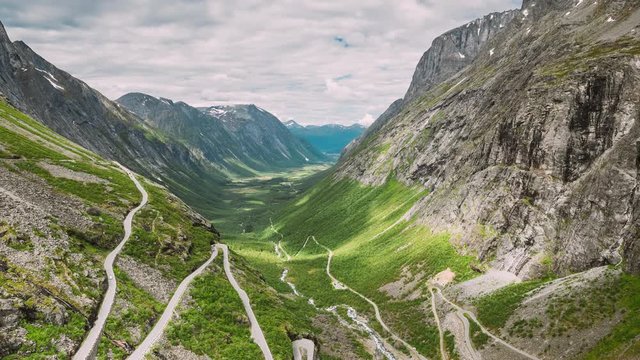 Trollstigen, Andalsnes, Norway. Cars Goes On Serpentine Mountain Road Trollstigen. Famous Norwegian Landmark And Popular Destination. Norwegian County Road 63 In Summer Day. 4K