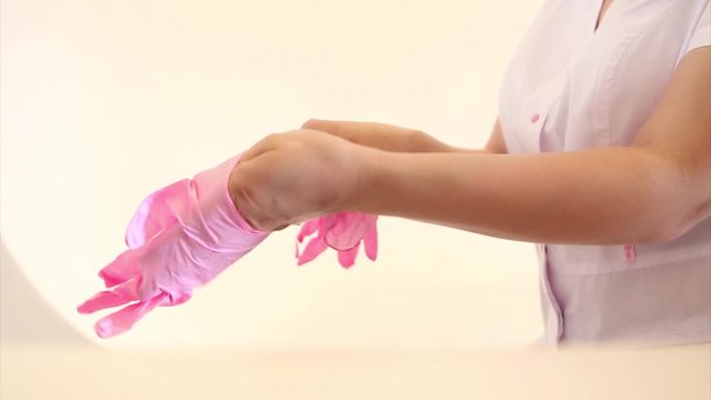 The doctor puts rubber gloves on his hand. the medic is preparing for surgery. Concept of medicine, medical instruments, healthcare. Isolated, copy space