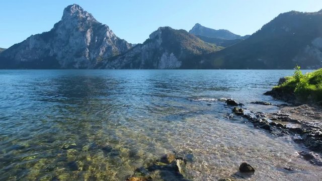 Peaceful autumn morning view to Traunsee lake and Traunstein mountain in far, Upper Austria.