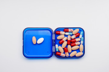 pile of medicine capsules in a box, pharmaceutical product, medicine in a health container.