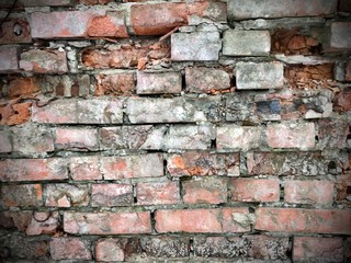 a wall of bricks of white, orange, gray colors. Background, texture, bumps, naturalness, vintage