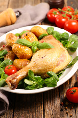 grilled chicken leg with roasted potato and lettuce