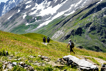 Fototapeta na wymiar Elderly tourists walking in the mountains of the French Alps.