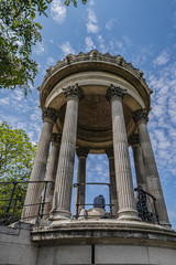 Parc des Buttes-Chaumont (1867) - Public Park in northeastern Paris. Most famous feature of park is Temple de la Sibylle (1867) - miniature version of ancient Roman Temple of Vesta. Paris, France.