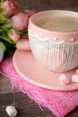 Hot chocolate in knitted cup with heart, pink marshmallow for valentine's day