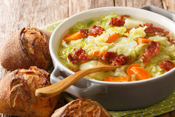 Autumn vegetable soup with fried bacon closeup in a bowl. horizontal