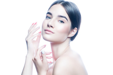 Naklejka premium Beautiful woman applying cream on her face, perfect skin, nude natural makeup. Isolated. White background. Skincare facial treatment concept