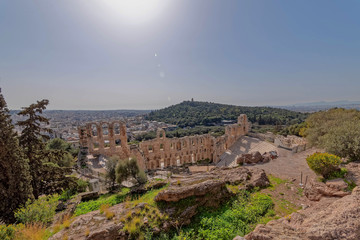 Obraz premium Greece, Herodium open odeon under Acropolis and Athens panoramic view under hot burning sun with light lens flare