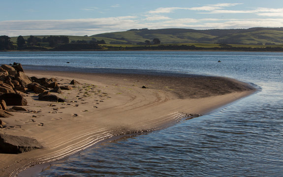 Surat Bay Owaka beach. Catlins New Zealand. Sand and water. Shoreline.