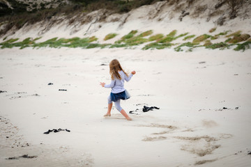 Little girl playing on beach at Portland, Victoria Australia