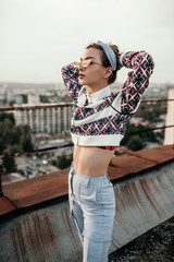 Trendy female resting on rooftop