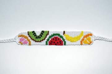 Handmade unique friendship bracelet with fruit pattern isolated on white background