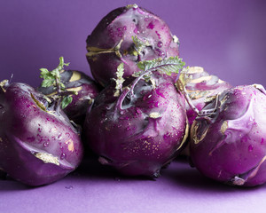 Kohlrabi cabbage on a purple background, closeup