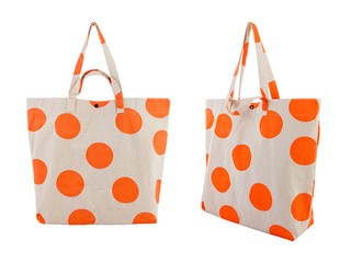 White canvas bag with random orange dots pattern isolated on white background.