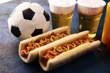 Grilled hot dogs with mustard and ketchup on the table with draft beer for football soccer party...