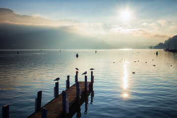 old wooden pier at sunrise by the lake