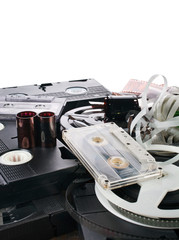 Vintage film camera rolls, old audio and video casettes with tape and foto strip isolated on a white background.