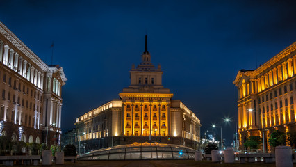 Obraz premium Night view of the architectural ensemble of three government buildings from the communist era in central Sofia, the capital of Bulgaria.