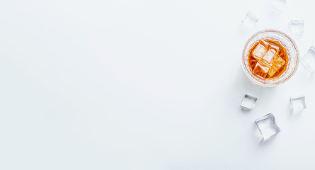 glass of whiskey with ice on a white background with place for text