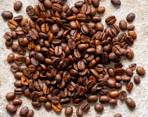 Fresh coffee beans on a stone surface