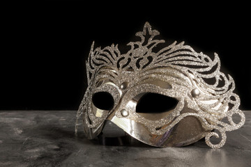 silvery carnival mask on dark