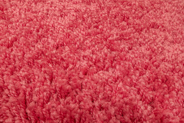 abstract background of warm artificial pink fur on a knitted base close up