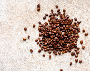 Fresh coffee beans on a stone surface