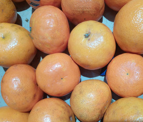 tasty yellow tangerines lie on the table