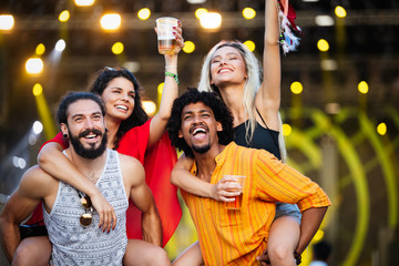 Group of friends having fun time at music festival