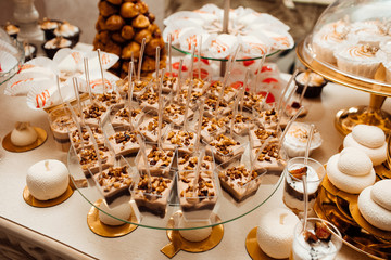 Candy bar. Table with different sweets for party. Delicious sweet buffet with cupcakes. Sweet holiday buffet with cupcakes and other desserts.