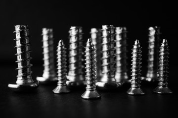 Screws close-up on a dark background, macro photo. Repair concept.