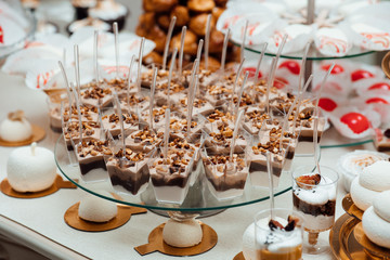 Candy bar. Table with different sweets for party. Delicious sweet buffet with cupcakes. Sweet holiday buffet with cupcakes and other desserts.