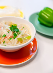 Soup with cellophane noodles, chicken and sweet green pepper.