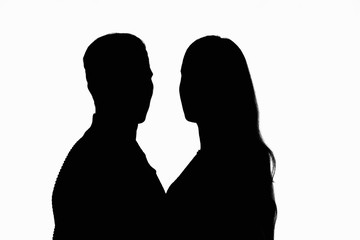 Two people in a counter-light looked into the frame