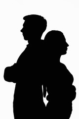 Dark silhouettes of a young couple on a white background