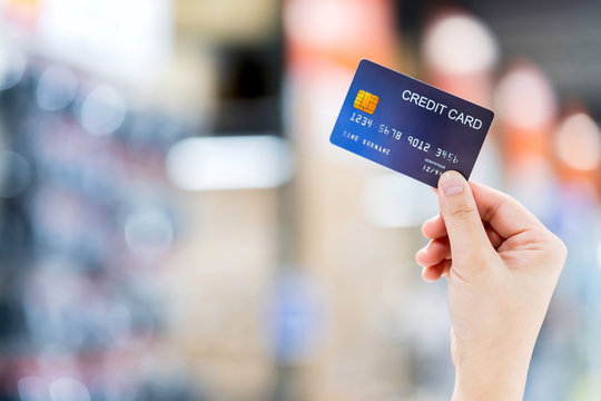 business shopping merchant ideas concept Close up of woman hand holding credit card for shopping with abstract blur mall background