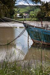 Fototapeta premium Owaka Catlins New Zealand. Abandoned boat. Ship at Catlins river