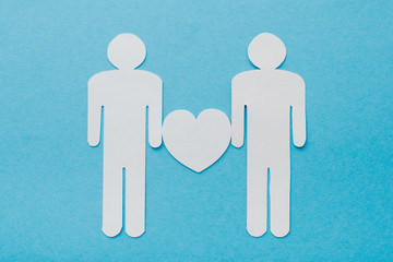 top view of paper cut figures of homosexual couple isolated on blue, human rights concept