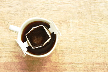 hot coffee drip powder with filter in cup on table