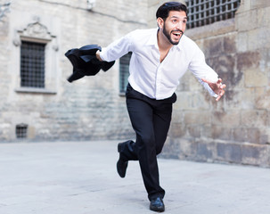 Hurrying man running along old street