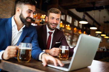 Business people drink beer after work. Businessmen enjoy a beer.