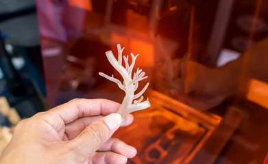 hand with object in shape of medically accurate a human blood vessel printed on 3d printer