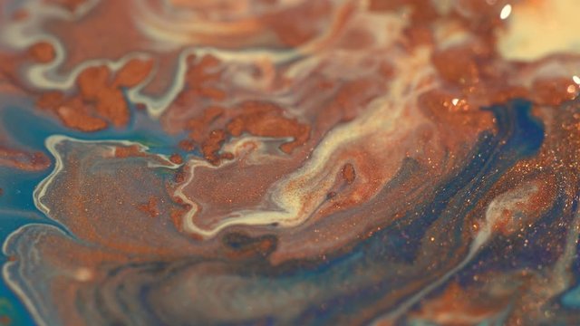 Copper, bronze, ochre, yellow, blue colors mix. Liquid glitter texture. Abstract background