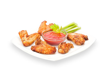 Delicious Crispy Chicken Wings in batter with celery sticks and ketchup