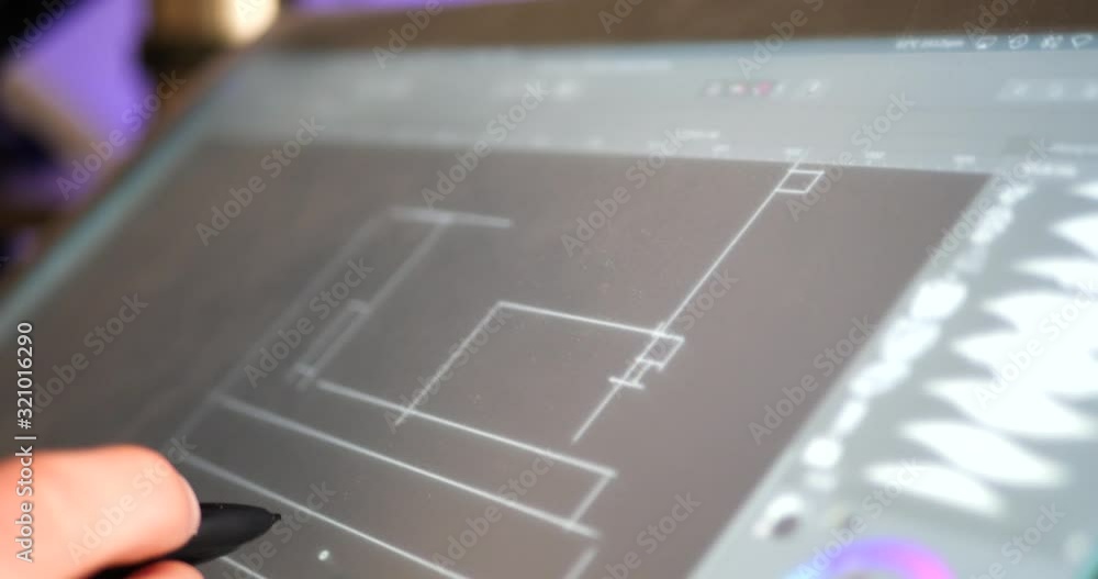Wall mural an architect drafting out blueprints or concept art for a building project on a digital graphic tabl